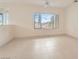 Spacious main bedroom with natural light, neutral tones, tile flooring, ceiling fan, and a large window at 538 Cypress Gardens Pl, Henderson, NV 89012