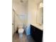 A modern bathroom with a vanity, toilet, shower, and tile flooring at 538 Ylang Pl, Henderson, NV 89015