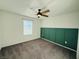 Cozy bedroom featuring a ceiling fan and a wall panel accent at 538 Ylang Pl, Henderson, NV 89015