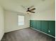 Bedroom featuring carpet, green wood accent wall, and a window at 538 Ylang Pl, Henderson, NV 89015