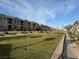 Green common area, with trees, sidewalks, and community buildings, enhances the neighborhood's appeal at 538 Ylang Pl, Henderson, NV 89015