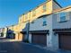 Exterior row of two-story townhomes featuring garages and stucco facades at 538 Ylang Pl, Henderson, NV 89015