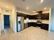 Well-equipped kitchen showcasing stainless steel appliances and tile floors at 538 Ylang Pl, Henderson, NV 89015