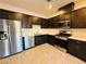 Modern kitchen features stainless steel appliances and dark cabinets at 538 Ylang Pl, Henderson, NV 89015