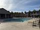 Community pool with lounge chairs and tables offers a refreshing spot to relax and socialize in the neighborhood at 538 Ylang Pl, Henderson, NV 89015