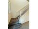 Carpeted staircase featuring white railing and natural light, offering a seamless transition between levels at 538 Ylang Pl, Henderson, NV 89015