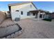 Spacious backyard features a covered patio, gravel, and a low block wall for a garden bed at 6165 Highland Gardens Dr, North Las Vegas, NV 89031