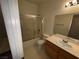 Bathroom with a shower-tub combo with sliding glass doors and a single sink vanity at 6165 Highland Gardens Dr, North Las Vegas, NV 89031