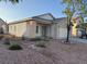 Quaint single story home with a two-car garage and desert landscaping at 6165 Highland Gardens Dr, North Las Vegas, NV 89031