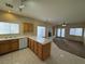 Modern kitchen featuring an island, tile floors, and plenty of natural light from the surrounding windows at 6165 Highland Gardens Dr, North Las Vegas, NV 89031