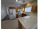 Updated kitchen with an island, stainless steel appliances, tile floors, and bright lighting at 6165 Highland Gardens Dr, North Las Vegas, NV 89031