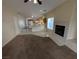 Open-concept living room with a cozy fireplace and views into the bright eat-in kitchen at 6165 Highland Gardens Dr, North Las Vegas, NV 89031