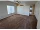 Spacious living room featuring neutral walls, carpet flooring, and a ceiling fan at 6165 Highland Gardens Dr, North Las Vegas, NV 89031