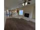 The comfortable living room features carpet and tile flooring, plus a warming fireplace at 6165 Highland Gardens Dr, North Las Vegas, NV 89031