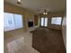 This living room offers dual pane windows and a fireplace with tile and carpet flooring at 6165 Highland Gardens Dr, North Las Vegas, NV 89031