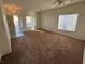 Inviting living room with neutral walls, carpet flooring, and bright windows letting in natural light at 6165 Highland Gardens Dr, North Las Vegas, NV 89031
