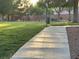 Community park area featuring green grass and a walking path at 6165 Highland Gardens Dr, North Las Vegas, NV 89031