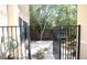 View of a backyard with a gate leading to a seating area surrounded by lush trees and shrubs at 6437 Boatbill St, North Las Vegas, NV 89084