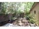 Backyard with a bench surrounded by trees, plants, and a brick wall providing privacy at 6437 Boatbill St, North Las Vegas, NV 89084