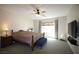 Spacious bedroom featuring a ceiling fan, large window, and comfortable furniture at 6437 Boatbill St, North Las Vegas, NV 89084