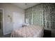 Cozy bedroom with leafy wall decor, neutral tones, and ample closet space for relaxation and storage at 6437 Boatbill St, North Las Vegas, NV 89084