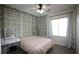 Charming bedroom with floral accents, vanity, and natural light, creates a serene and inviting space at 6437 Boatbill St, North Las Vegas, NV 89084