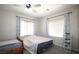 Bedroom with two beds, carpet, and a ceiling fan, creating a comfortable and functional living space at 6437 Boatbill St, North Las Vegas, NV 89084