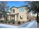 Two-story home with neutral stucco, landscaped front, and attached garage at 6437 Boatbill St, North Las Vegas, NV 89084