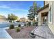 Landscaped front yard with rock garden, brick walkway, and view of the neighborhood at 6437 Boatbill St, North Las Vegas, NV 89084