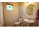 Cozy half bathroom with decorative mirror, stylish sink, and a decorative window at 6437 Boatbill St, North Las Vegas, NV 89084