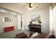 Bright and airy living room with a piano, art, and natural light at 6437 Boatbill St, North Las Vegas, NV 89084