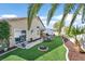 Large landscaped backyard featuring artificial turf, covered patio and exercise area at 688 Quiet Stream Ct, Henderson, NV 89052