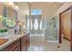 Bathroom showcasing double sinks, soaking tub and glass shower with bright natural light at 688 Quiet Stream Ct, Henderson, NV 89052