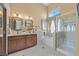 Bathroom featuring double sinks, large tub, and a glass-enclosed shower at 688 Quiet Stream Ct, Henderson, NV 89052