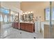 Bathroom featuring double sinks, a large tub, and a glass-enclosed shower at 688 Quiet Stream Ct, Henderson, NV 89052