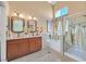 Bathroom featuring double sinks, soaking tub, standing shower, and window for natural light at 688 Quiet Stream Ct, Henderson, NV 89052