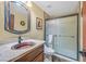 Bathroom featuring artistic basin sink, stone counters, a vanity and frameless glass shower at 688 Quiet Stream Ct, Henderson, NV 89052
