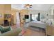 Large bedroom with wood floors, full dresser, work space, and access to ensuite bath at 688 Quiet Stream Ct, Henderson, NV 89052