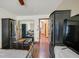 Bedroom with wood floors and sliding door mirrored closet at 688 Quiet Stream Ct, Henderson, NV 89052