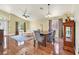 Dining area with vintage cabinet, hardwood floors and modern furniture at 688 Quiet Stream Ct, Henderson, NV 89052