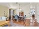 Dining area with hardwood floors, a vintage cabinet and modern furniture at 688 Quiet Stream Ct, Henderson, NV 89052