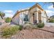 Charming single-story home with desert landscaping and a cozy front porch bench at 688 Quiet Stream Ct, Henderson, NV 89052