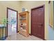 Hallway with views of the backyard, and a wooden shelving unit for books and decor at 688 Quiet Stream Ct, Henderson, NV 89052