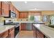 Modern kitchen with stainless steel appliances, granite countertops, and lots of cabinet storage at 688 Quiet Stream Ct, Henderson, NV 89052