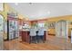 Kitchen island with seating and stainless steel refrigerator at 688 Quiet Stream Ct, Henderson, NV 89052