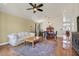 Open-concept living room with dining area, vaulted ceiling, hardwood floors and bright natural light at 688 Quiet Stream Ct, Henderson, NV 89052
