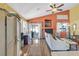 Bright living room featuring vaulted ceilings, wood floors, and sliding glass doors to outdoor living space at 688 Quiet Stream Ct, Henderson, NV 89052
