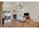 Bright living room with fireplace, wood look tile floors, ceiling fan, and access to the backyard at 688 Quiet Stream Ct, Henderson, NV 89052