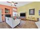 Cozy living room with a fireplace and large television at 688 Quiet Stream Ct, Henderson, NV 89052