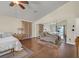 Bright bedroom with ceiling fan, wood look tile floors, mirrored closet, and decorative furnishings at 688 Quiet Stream Ct, Henderson, NV 89052